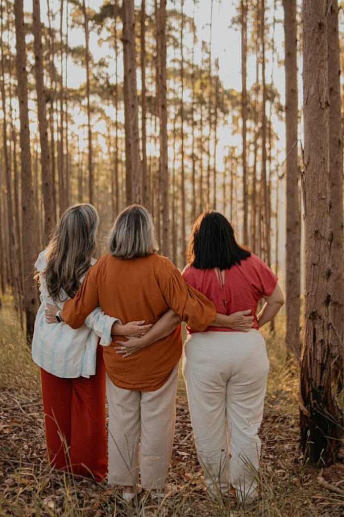 pexels-photo-24513647 Three women standing in a forest looking at each other